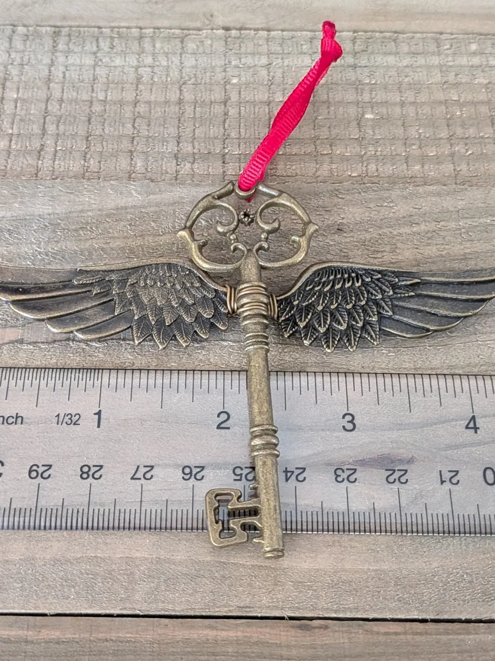 Vintage Brass Winged Key Ornament with Red Ribbon